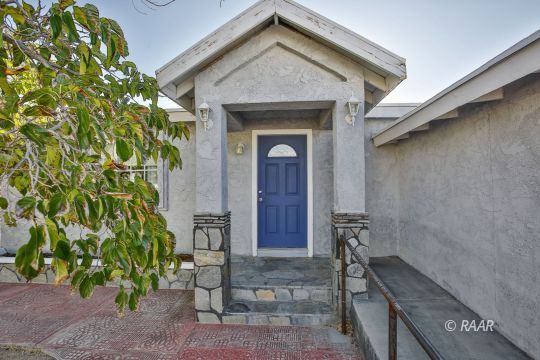 408 North Helena Street Ridgecrest, CA 93555 - Photo 2 of 22 a front view of a house with garden