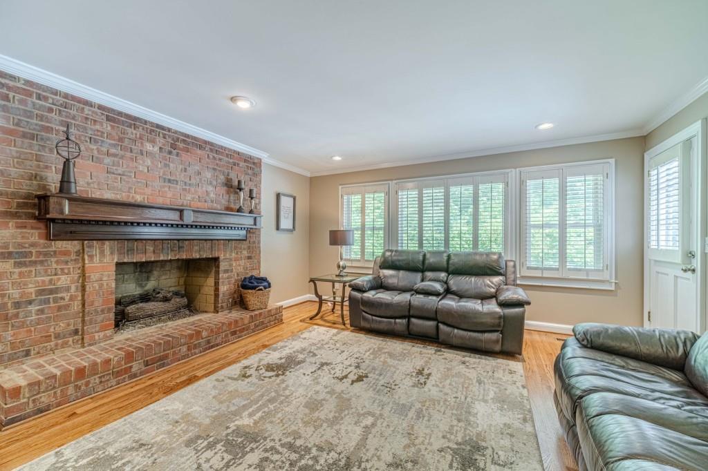 816 McDaniel Street Monroe, GA 30655 - Photo 11 of 52 a living room with furniture and a fireplace