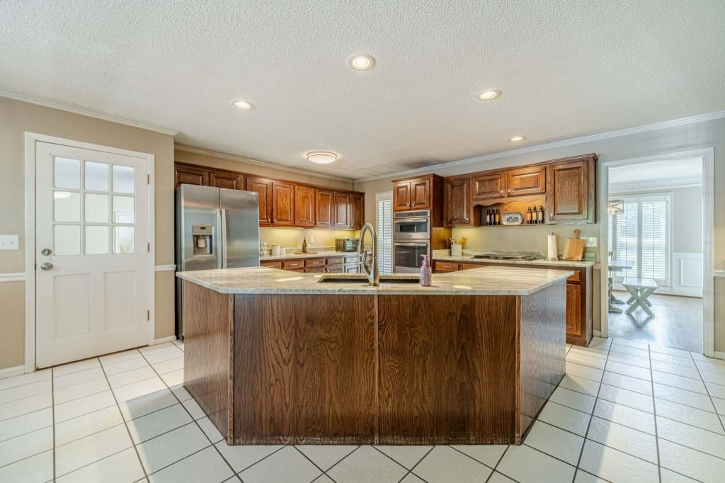 816 McDaniel Street Monroe, GA 30655 - Photo 15 of 52 a large kitchen with kitchen island granite countertop a large counter top and a dining table