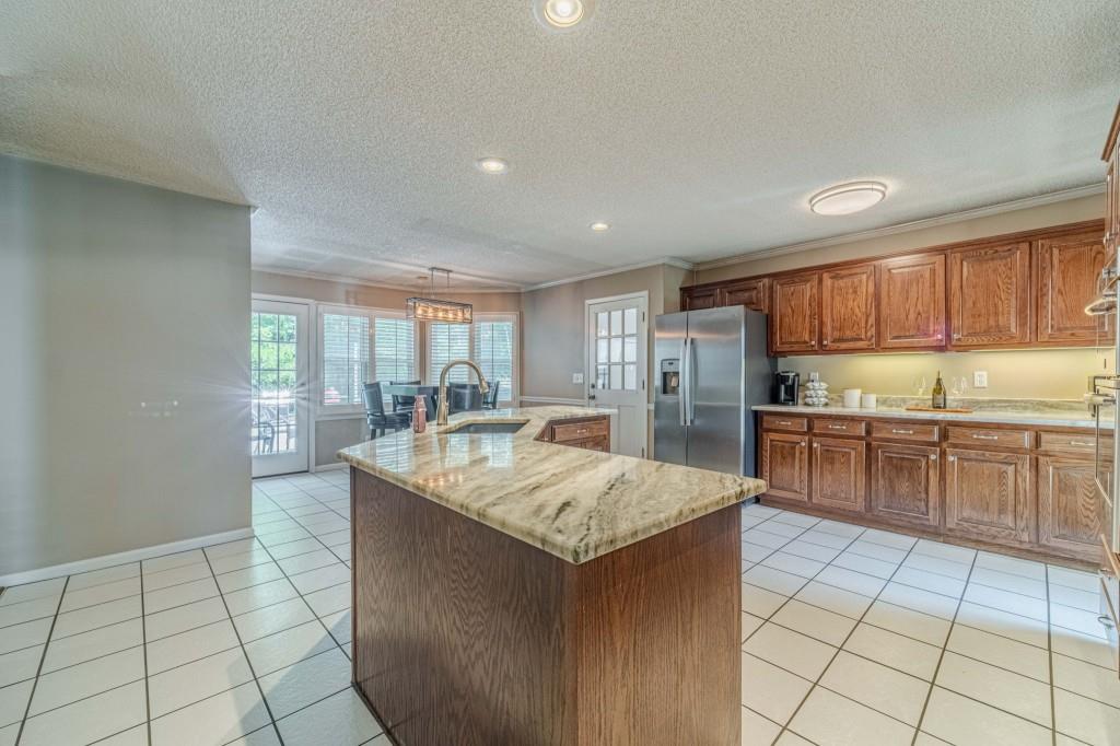 816 McDaniel Street Monroe, GA 30655 - Photo 16 of 52 a kitchen with counter top space cabinets and center island