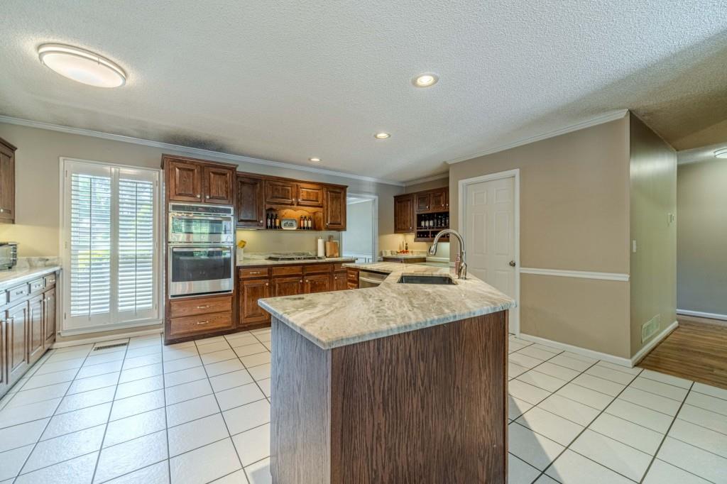 816 McDaniel Street Monroe, GA 30655 - Photo 17 of 52 a kitchen with stainless steel appliances granite countertop a refrigerator and a sink