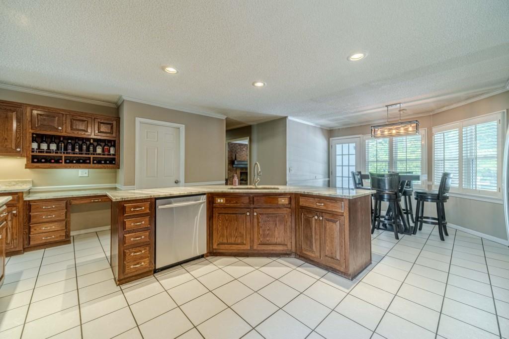 816 McDaniel Street Monroe, GA 30655 - Photo 18 of 52 a large kitchen with kitchen island a sink counter and chairs
