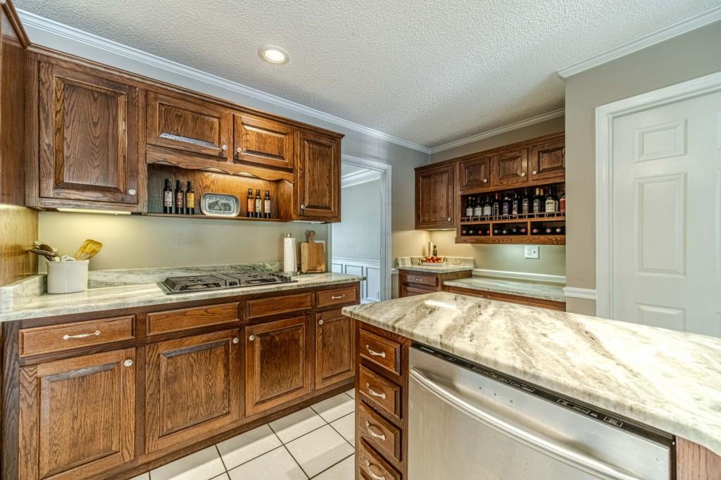 816 McDaniel Street Monroe, GA 30655 - Photo 19 of 52 a kitchen with stainless steel appliances granite countertop a stove and a sink