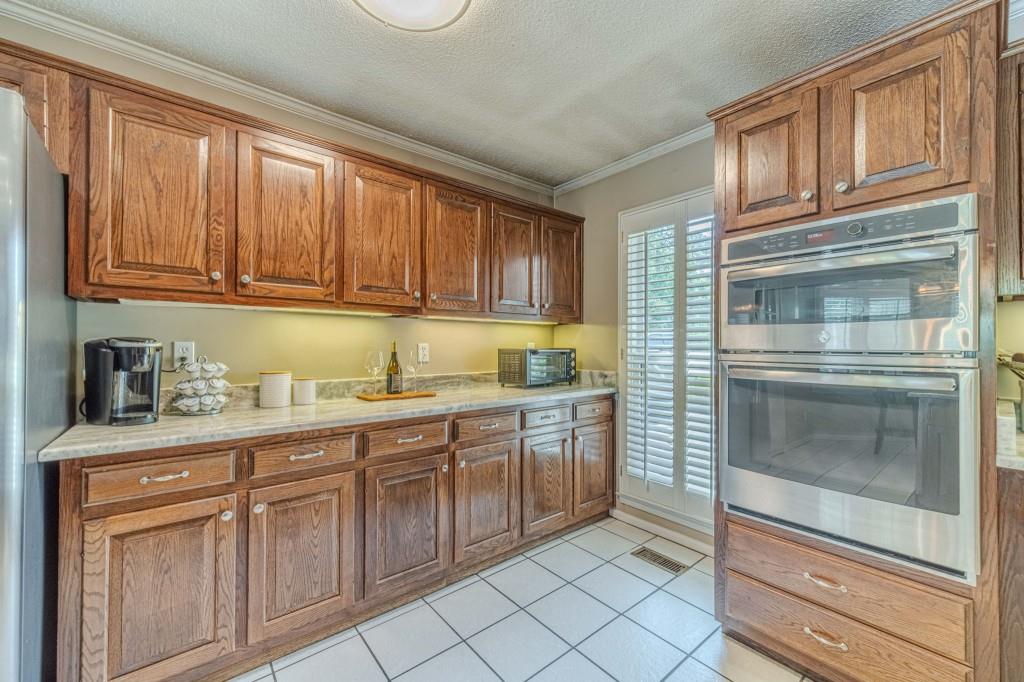 816 McDaniel Street Monroe, GA 30655 - Photo 20 of 52 a kitchen with granite countertop cabinets stainless steel appliances and a sink