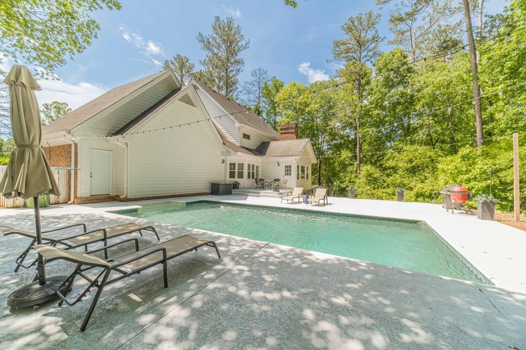 816 McDaniel Street Monroe, GA 30655 - Photo 2 of 52 a house with swimming pool in front of it