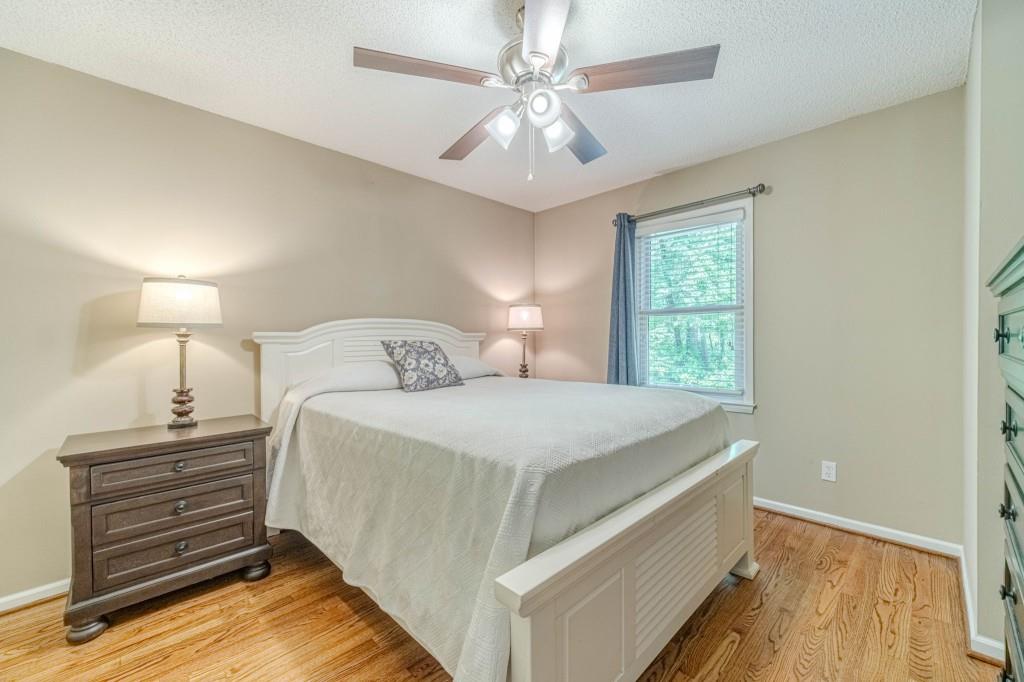 816 McDaniel Street Monroe, GA 30655 - Photo 23 of 52 a bedroom with a bed and a ceiling fan