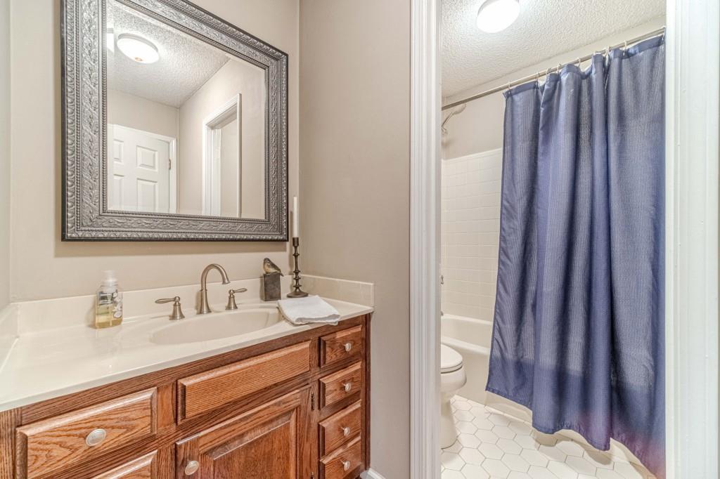 816 McDaniel Street Monroe, GA 30655 - Photo 25 of 52 a bathroom with a sink a toilet and shower