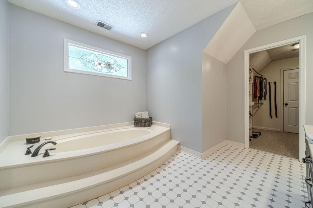 816 McDaniel Street Monroe, GA 30655 - Photo 31 of 52 a bathroom with a bathtub and a sink