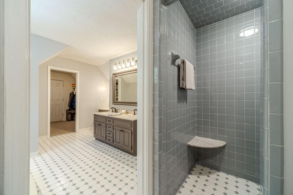 816 McDaniel Street Monroe, GA 30655 - Photo 32 of 52 a bathroom with a sink a toilet a mirror and shower