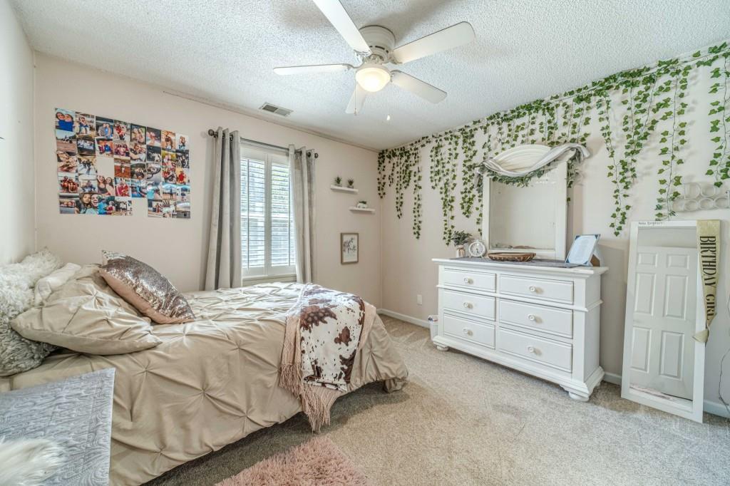 816 McDaniel Street Monroe, GA 30655 - Photo 33 of 52 a bedroom with a bed and a dresser