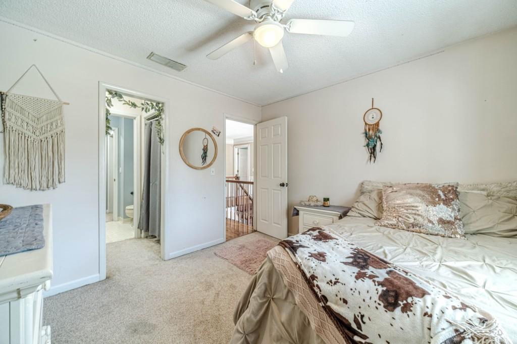 816 McDaniel Street Monroe, GA 30655 - Photo 34 of 52 a bedroom with a bed and a chandelier