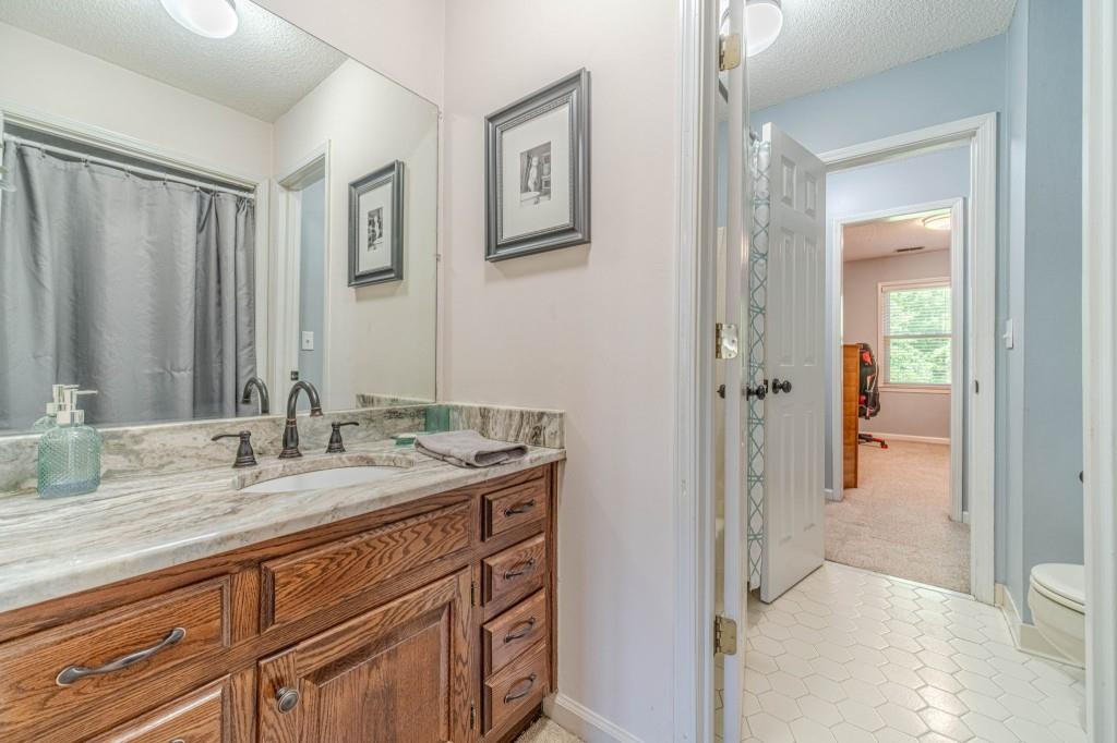 816 McDaniel Street Monroe, GA 30655 - Photo 35 of 52 a bathroom with a granite countertop sink mirror and double