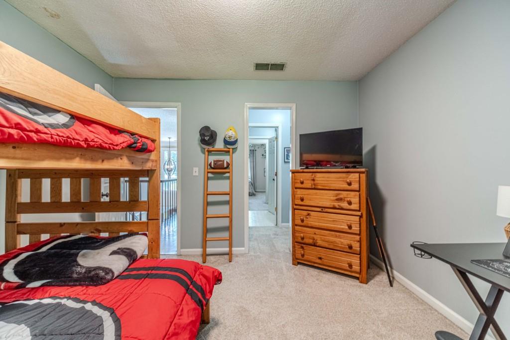 816 McDaniel Street Monroe, GA 30655 - Photo 37 of 52 a bedroom with a bed and furniture