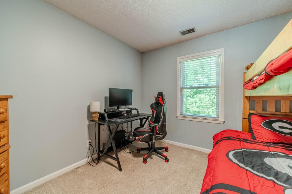 816 McDaniel Street Monroe, GA 30655 - Photo 38 of 52 a view of a workspace with furniture and a window