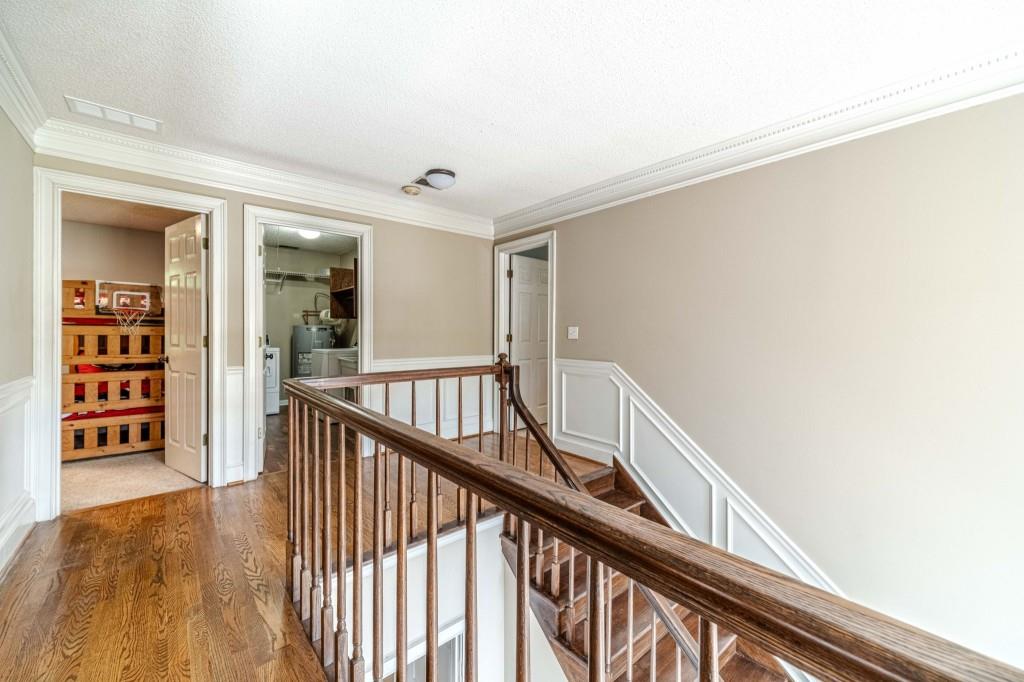 816 McDaniel Street Monroe, GA 30655 - Photo 40 of 52 a view of a hallway with wooden floor and staircase