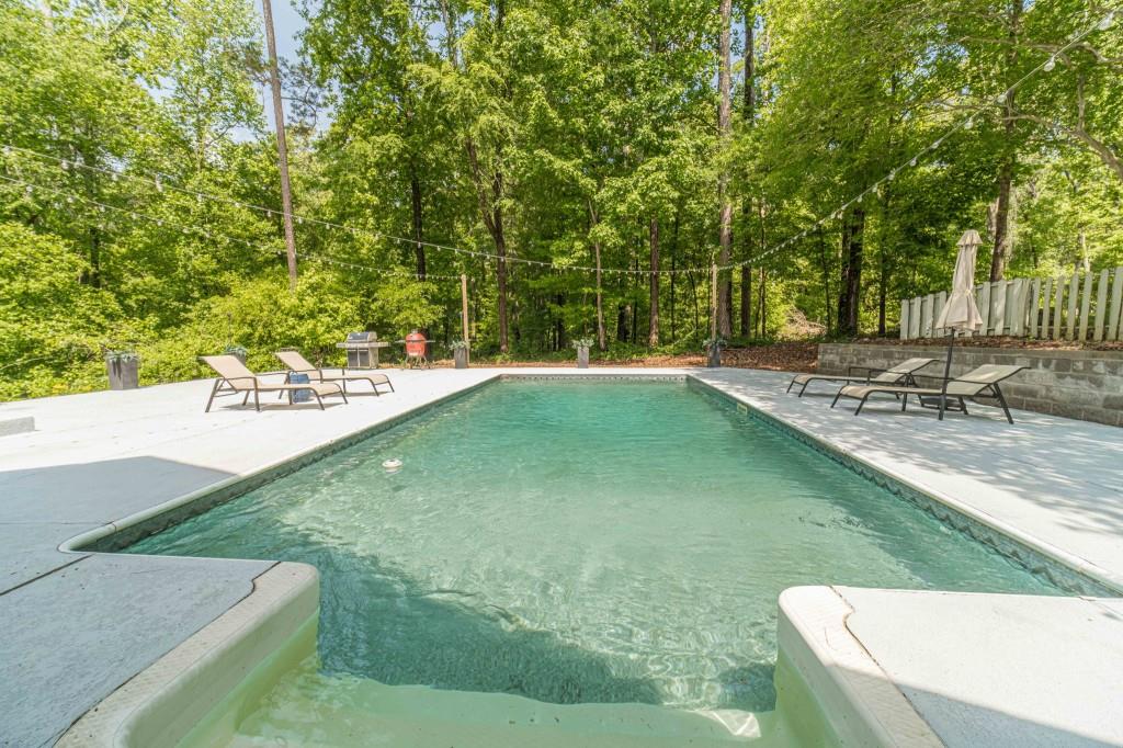 816 McDaniel Street Monroe, GA 30655 - Photo 45 of 52 a view of a swimming pool with a yard