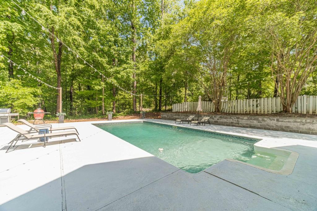 816 McDaniel Street Monroe, GA 30655 - Photo 46 of 52 a view of a swimming pool with a patio