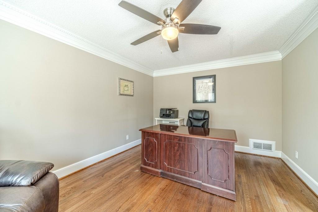 816 McDaniel Street Monroe, GA 30655 - Photo 8 of 52 a view of a workspace with furniture and wooden floor