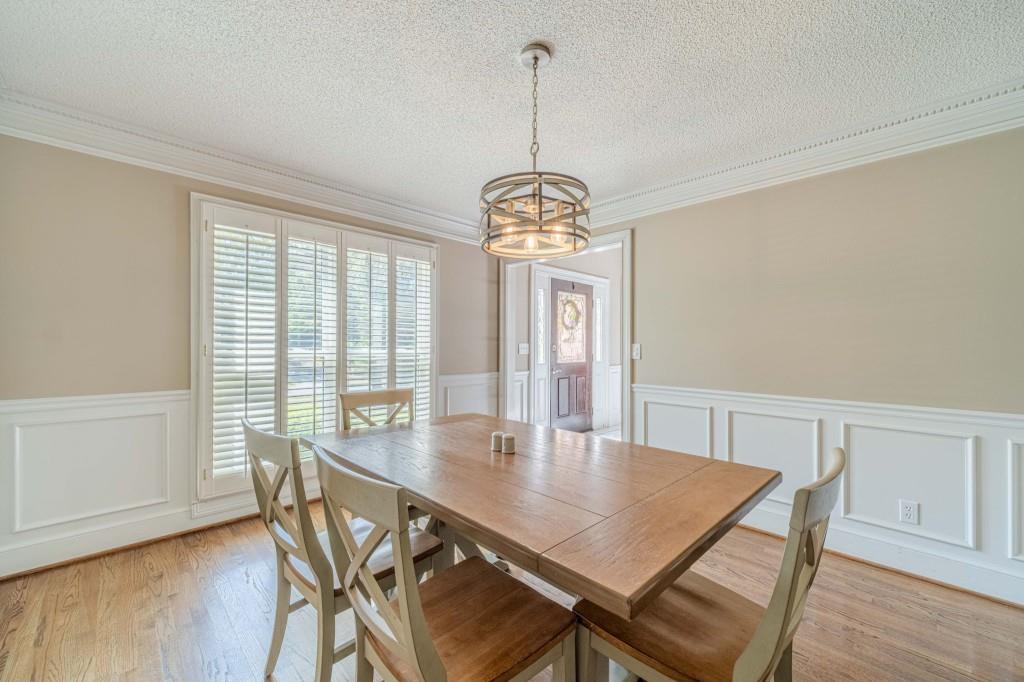 816 McDaniel Street Monroe, GA 30655 - Photo 10 of 52 a view of a dining room with furniture window and wooden floor