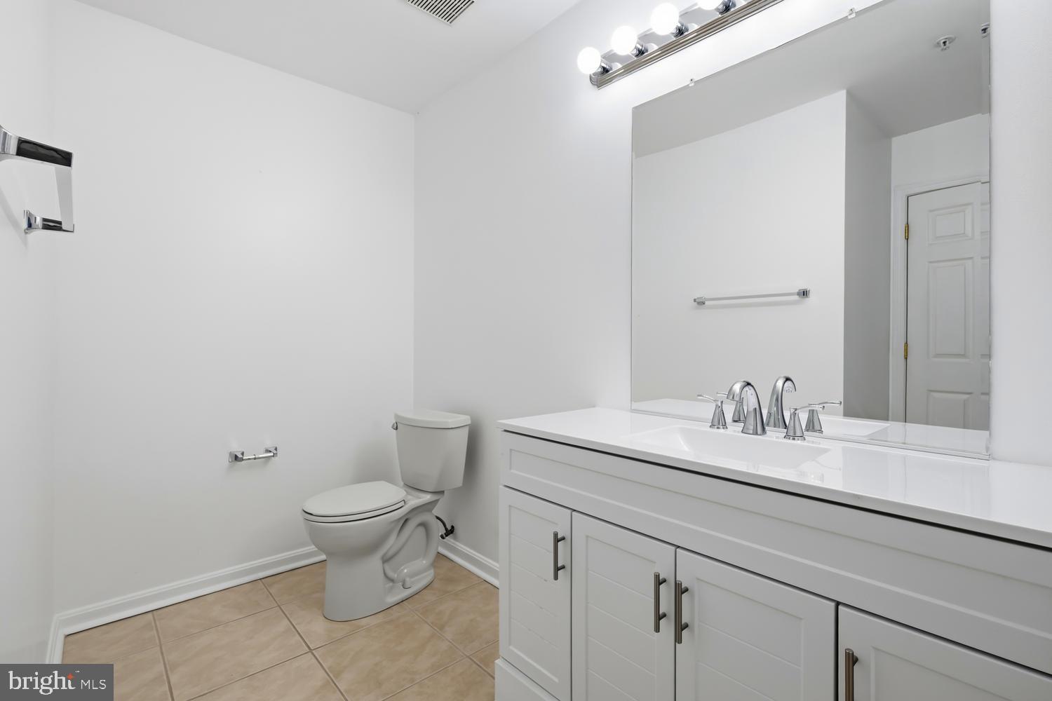 2627 Compass Drive Annapolis, MD 21401 - Photo 25 of 37 a bathroom with a granite countertop sink a toilet and a mirror