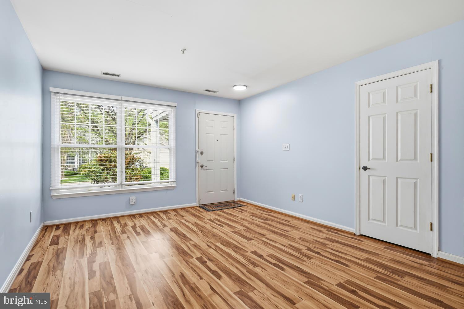 2627 Compass Drive Annapolis, MD 21401 - Photo 6 of 37 a view of an empty room with wooden floor and a window