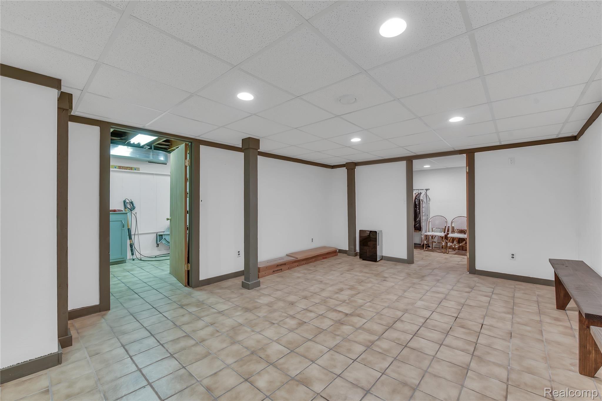 4110 Curtis Road Leonard, MI 48367 - Photo 29 of 46 basement rec room leading to storage and mechanical rooms