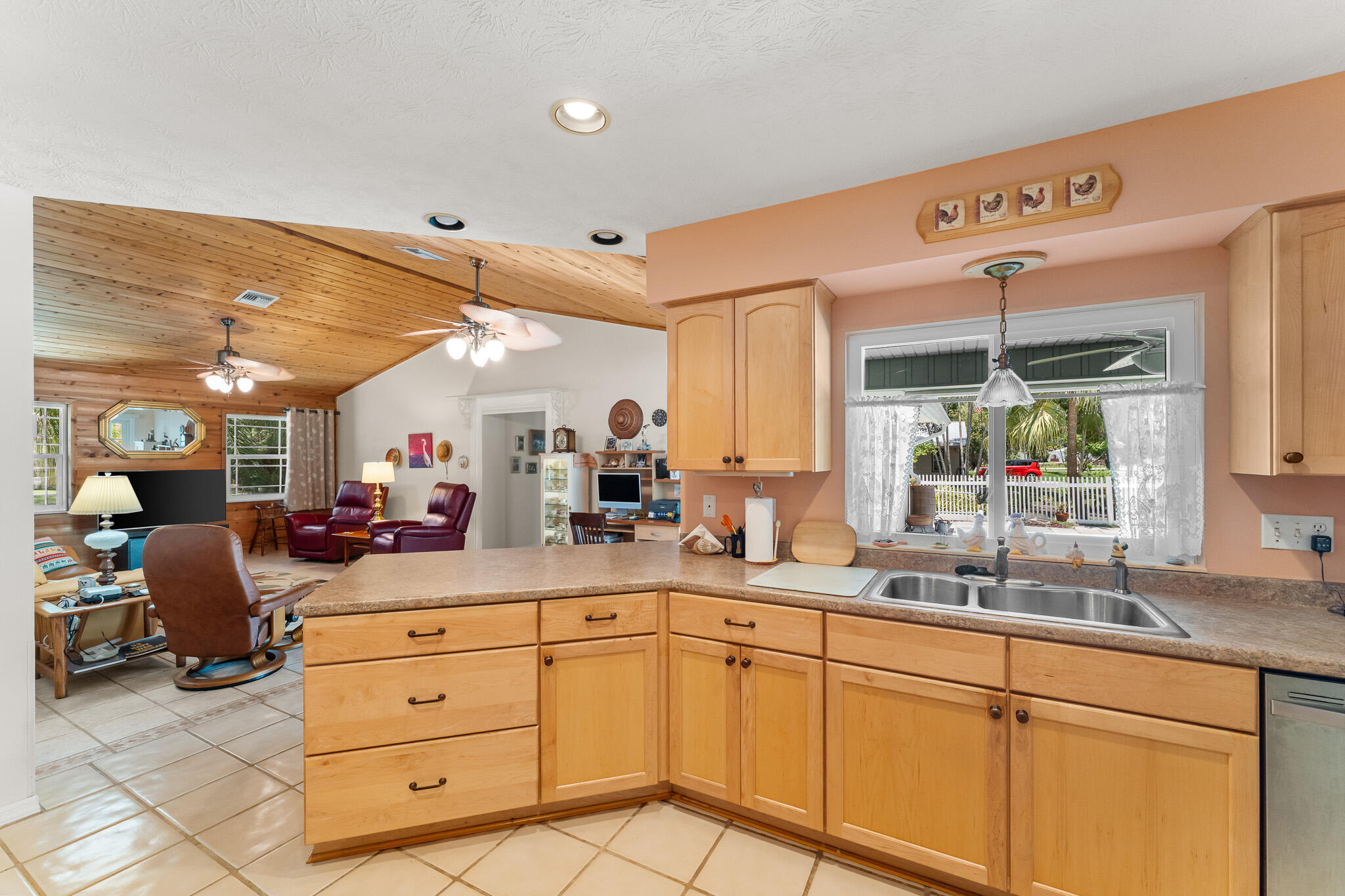 1653 Southwest 85th Terrace Stuart, FL 34997 - Photo 22 of 54 a kitchen with sink cabinets and living room view