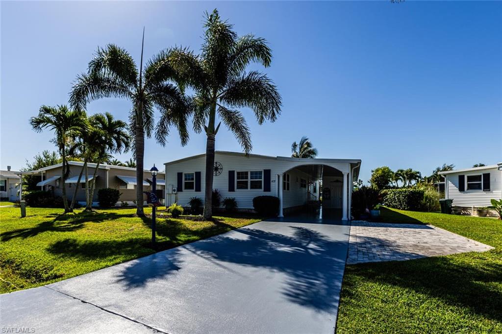 103 Audubon Road Naples, FL 34114 - Photo 7 of 7 a view of a house with swimming pool and a yard