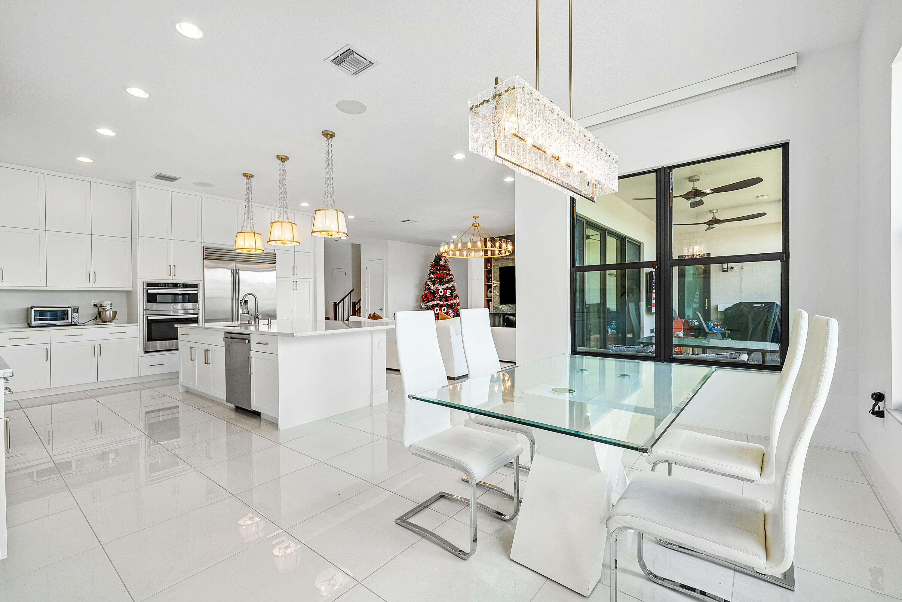20145 Castle Stuart Avenue Boca Raton, FL 33434 - Photo 13 of 95 a kitchen with white cabinets and white appliances