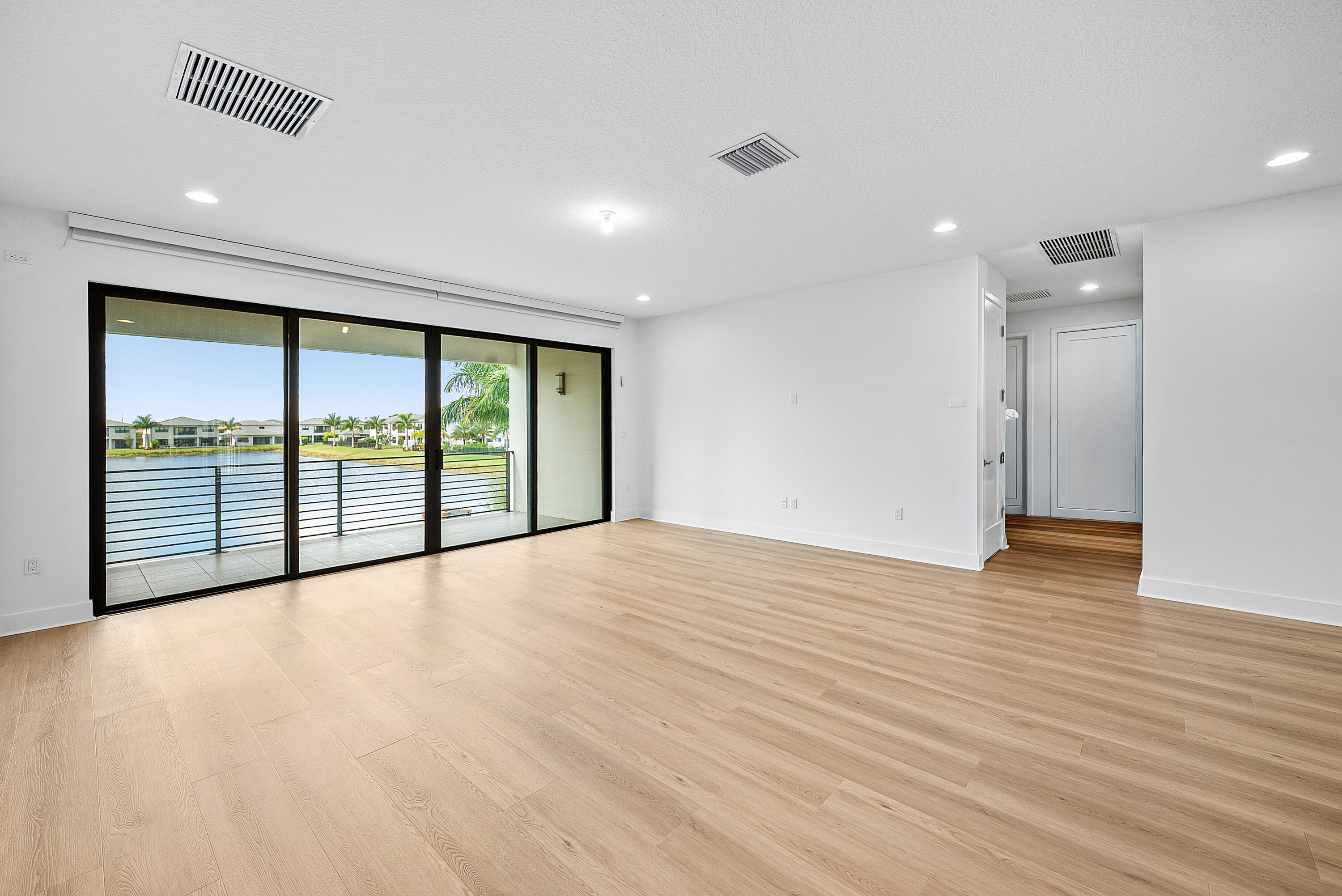 20145 Castle Stuart Avenue Boca Raton, FL 33434 - Photo 22 of 95 a view of an empty room with wooden floor and a window