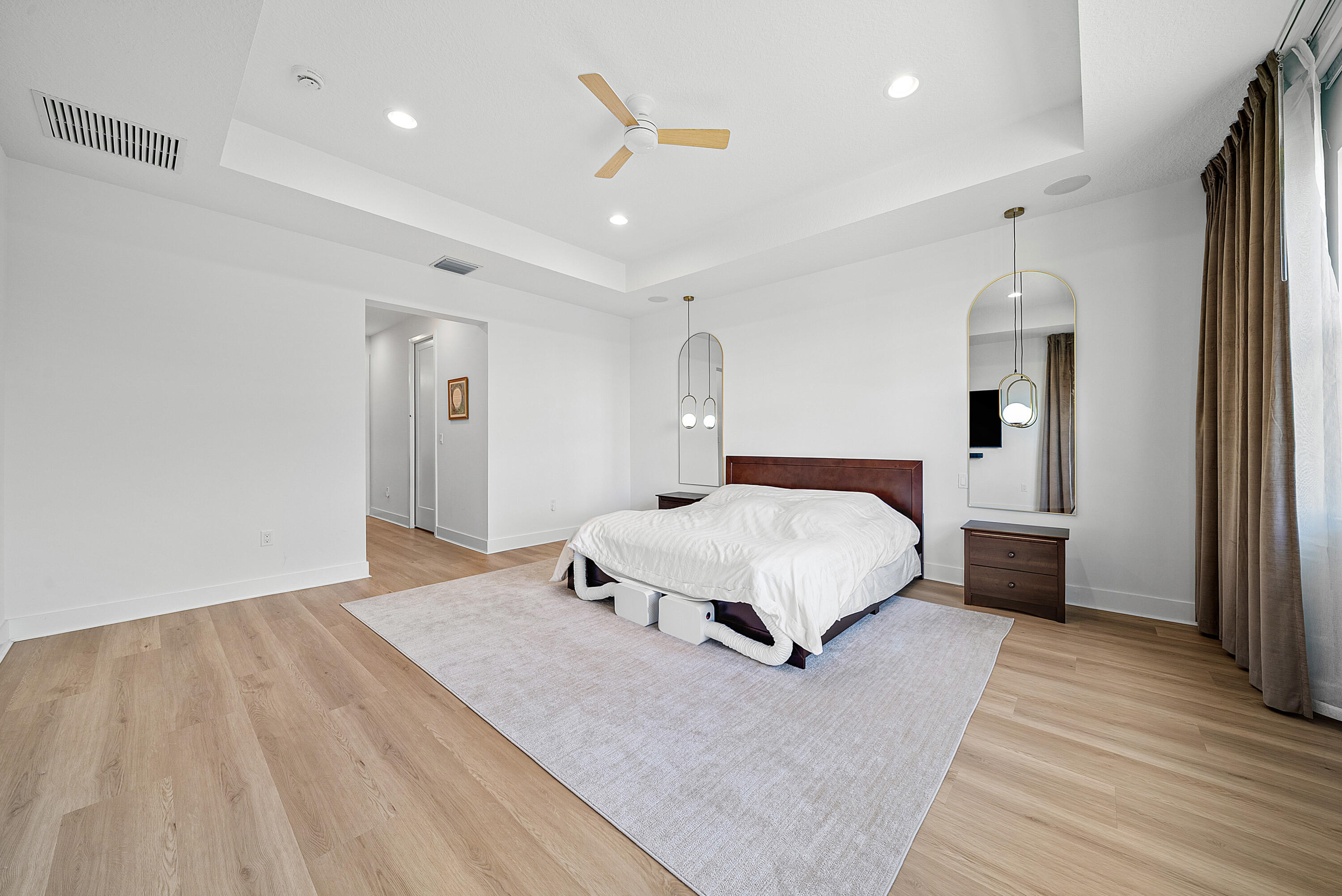 20145 Castle Stuart Avenue Boca Raton, FL 33434 - Photo 23 of 95 a spacious bedroom with a bed and a dresser