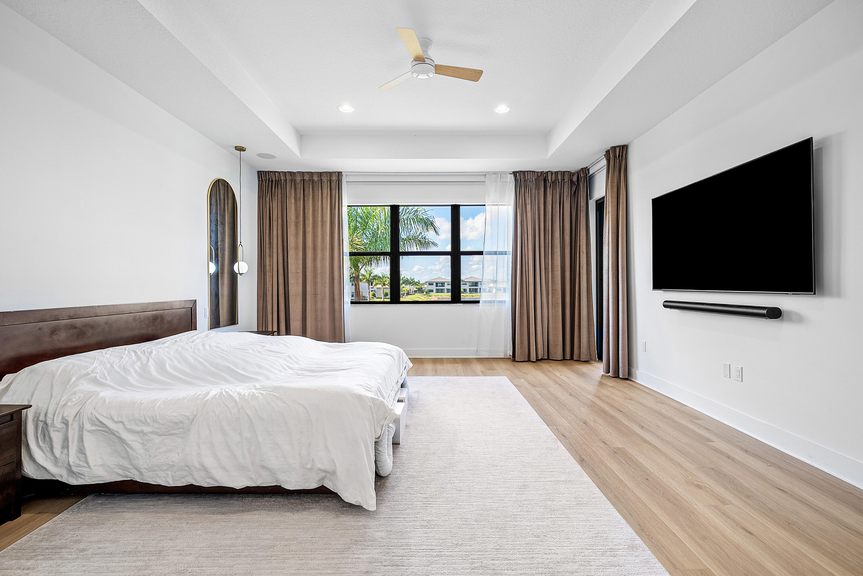 20145 Castle Stuart Avenue Boca Raton, FL 33434 - Photo 24 of 95 a bedroom with a bed and a flat screen tv