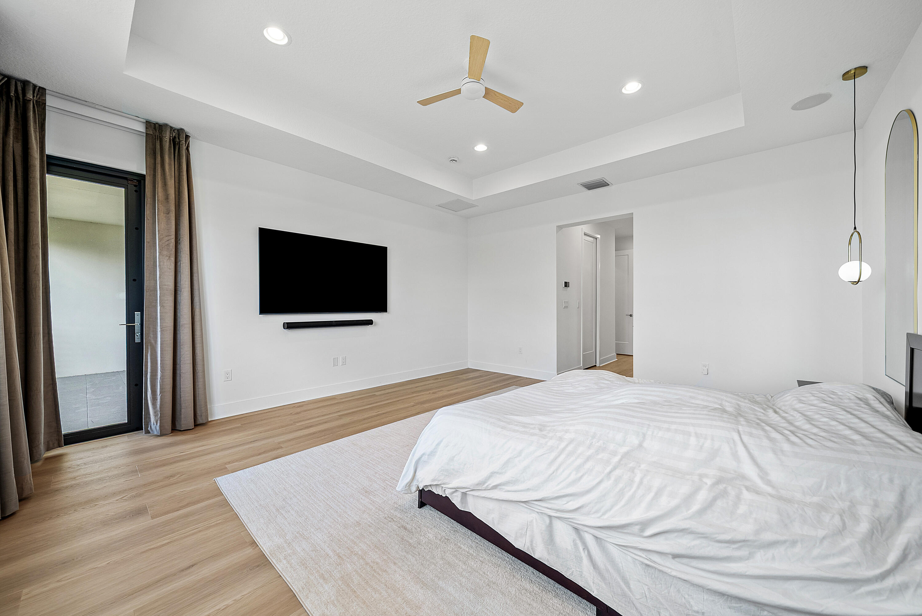 20145 Castle Stuart Avenue Boca Raton, FL 33434 - Photo 25 of 95 a bedroom with a bed and a flat screen tv