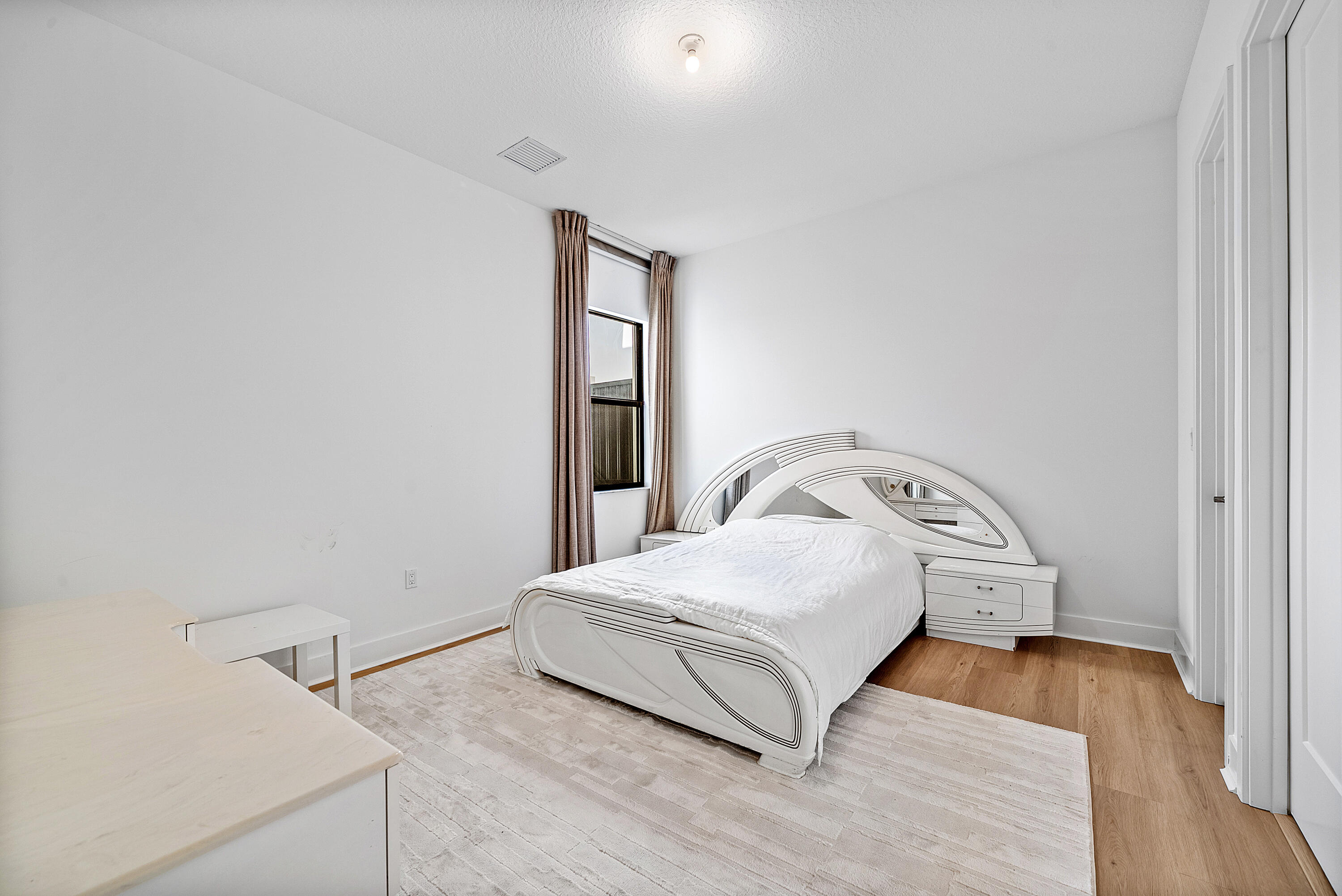 20145 Castle Stuart Avenue Boca Raton, FL 33434 - Photo 29 of 95 a bedroom with a bed and wooden floor