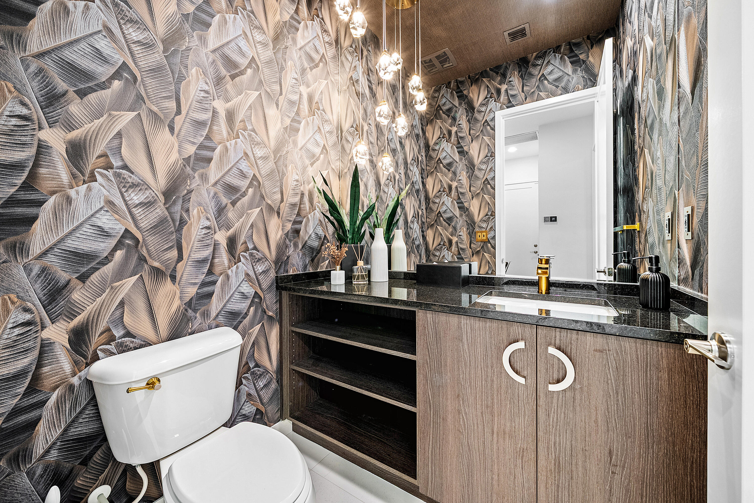 20145 Castle Stuart Avenue Boca Raton, FL 33434 - Photo 30 of 95 a bathroom with a granite countertop toilet sink and mirror