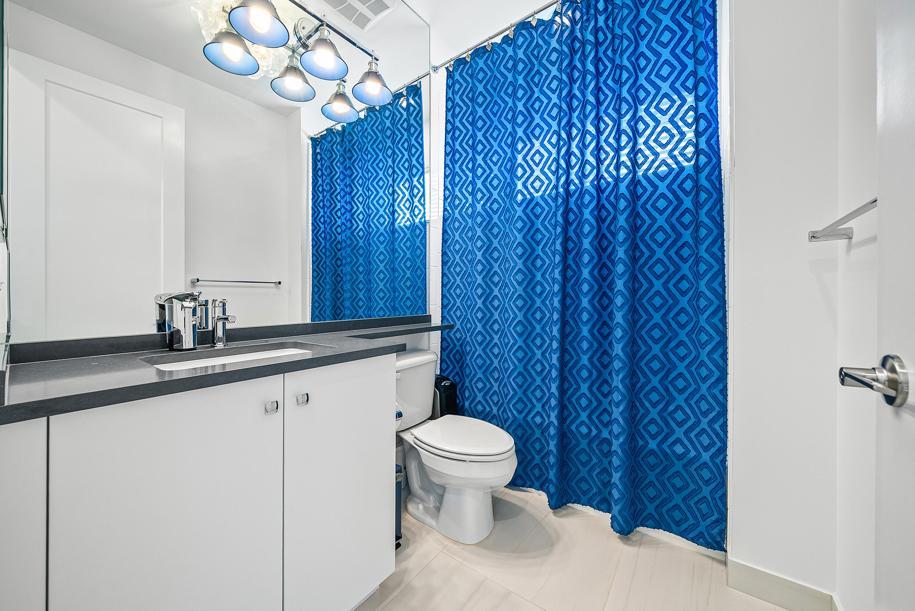 20145 Castle Stuart Avenue Boca Raton, FL 33434 - Photo 33 of 95 a bathroom with a sink a toilet and mirror