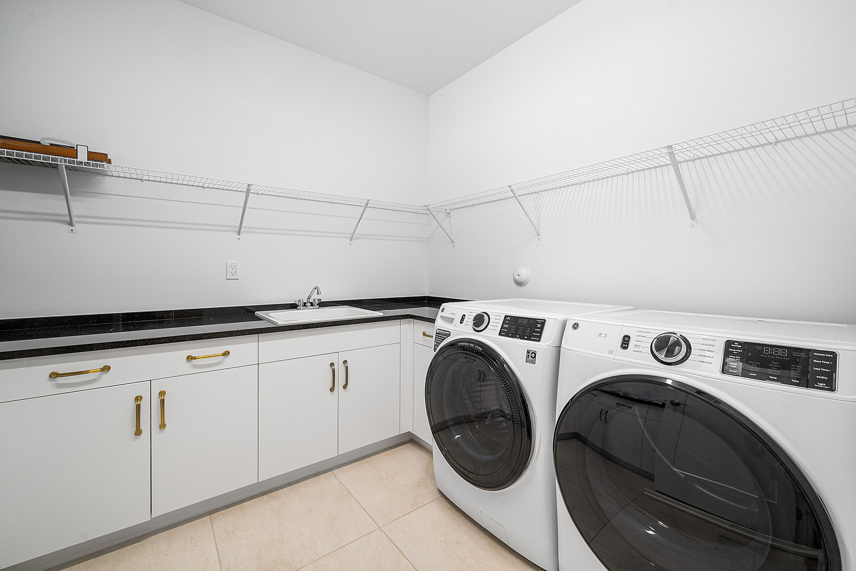 20145 Castle Stuart Avenue Boca Raton, FL 33434 - Photo 36 of 95 a utility room with dryer and washer