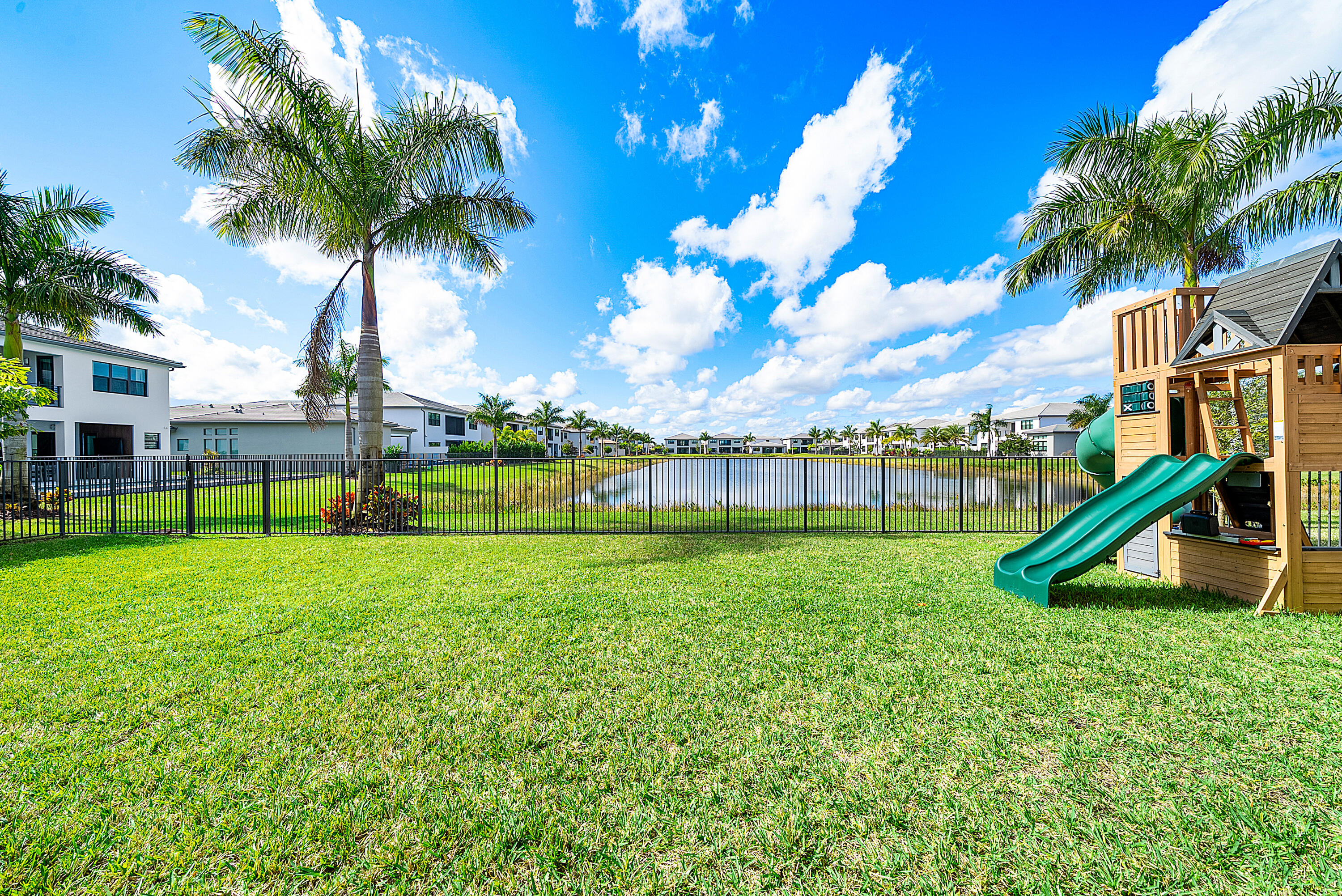 20145 Castle Stuart Avenue Boca Raton, FL 33434 - Photo 40 of 95 a view of a house with a backyard and a slide
