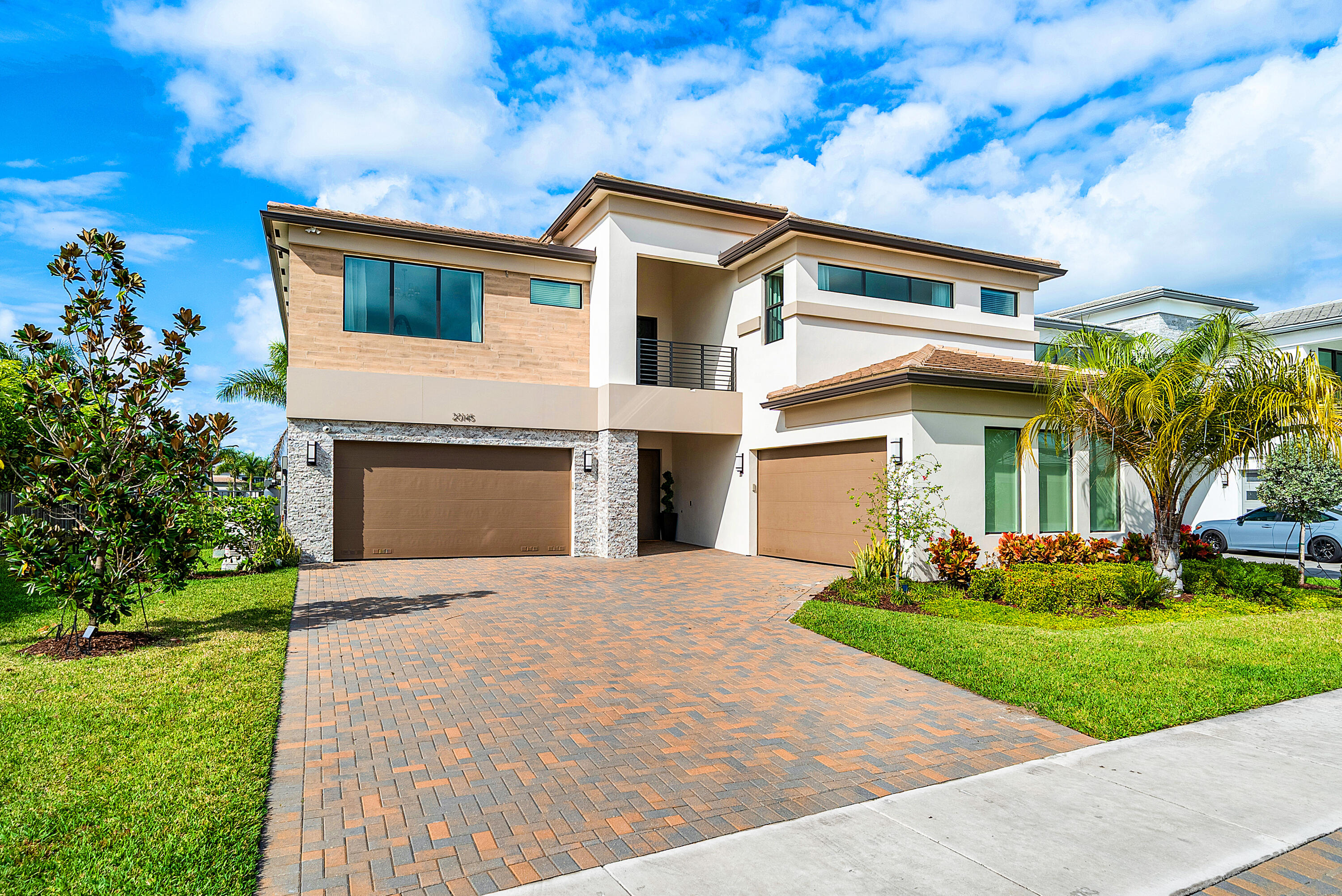 20145 Castle Stuart Avenue Boca Raton, FL 33434 - Photo 44 of 95 a front view of a house with a yard and garage