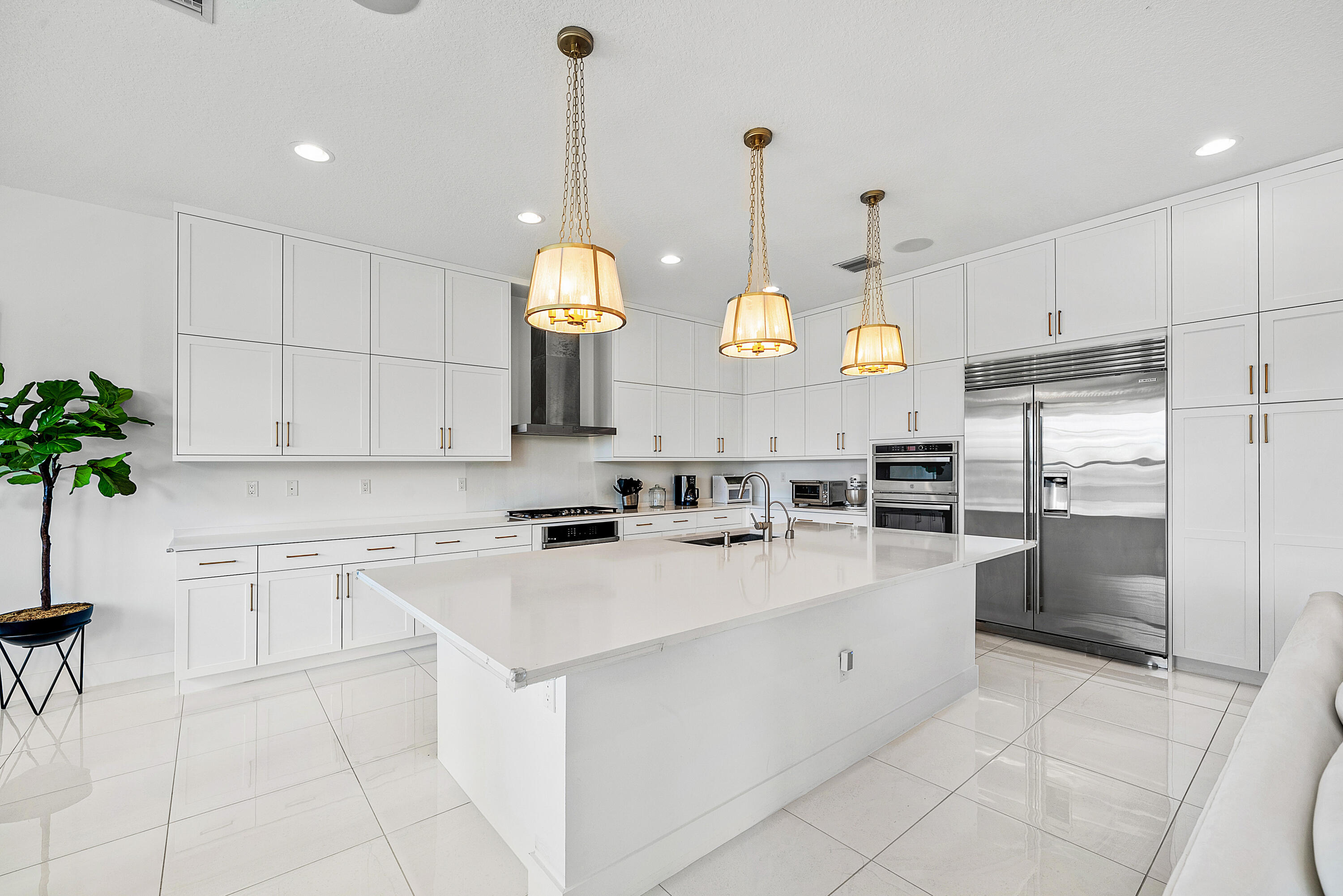 20145 Castle Stuart Avenue Boca Raton, FL 33434 - Photo 8 of 95 a kitchen with stainless steel appliances kitchen island granite countertop a sink a stove and refrigerator