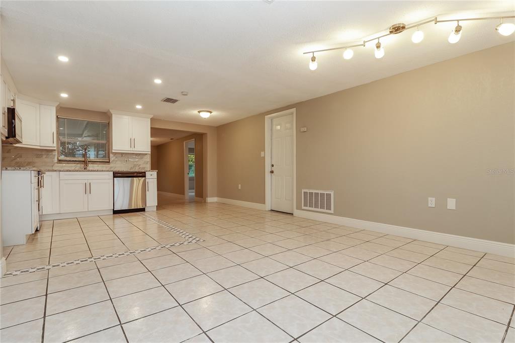 9226 Rainbow Lane Port Richey, FL 34668 - Photo 4 of 16 a kitchen with stainless steel appliances a refrigerator and a stove top oven