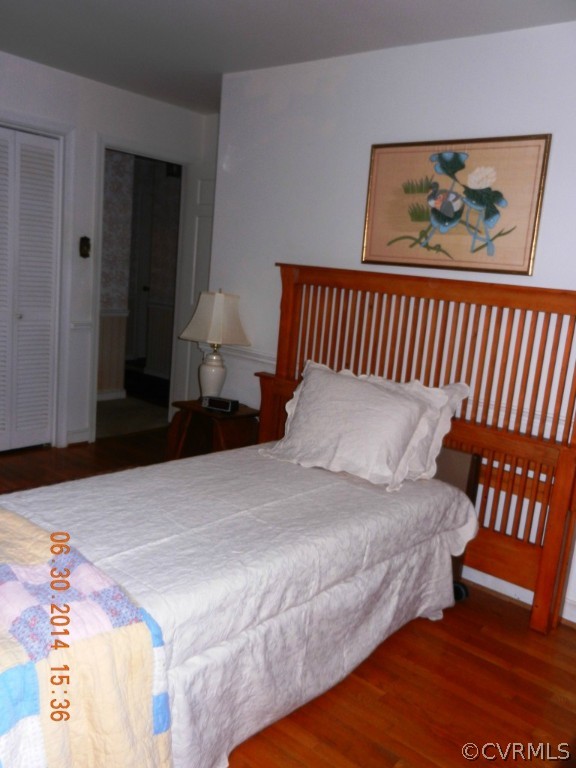10940 Weybridge Road Chester, VA 23831 - Photo 15 of 16 a bedroom with a bed and a painting on the wall