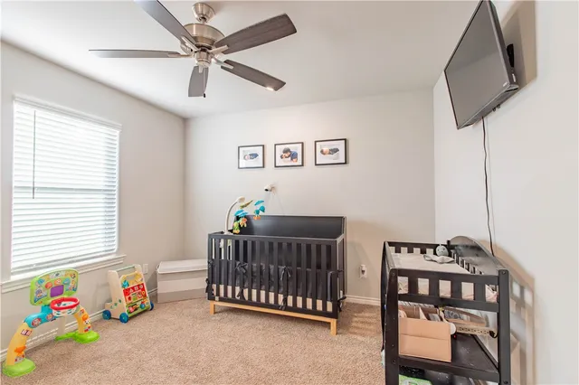 a bathroom with a granite countertop toilet sink and mirror