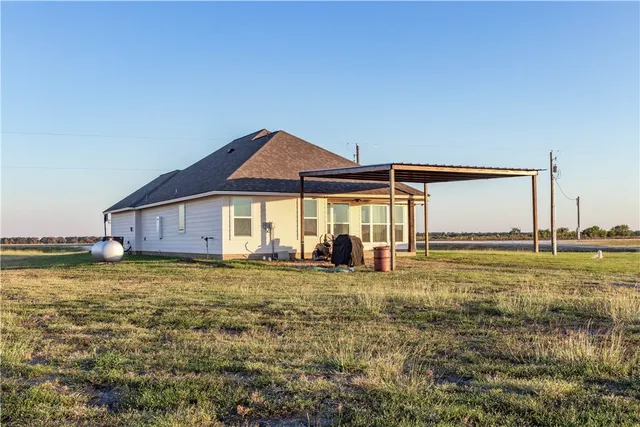 a view of a house with backyard porch and furniture