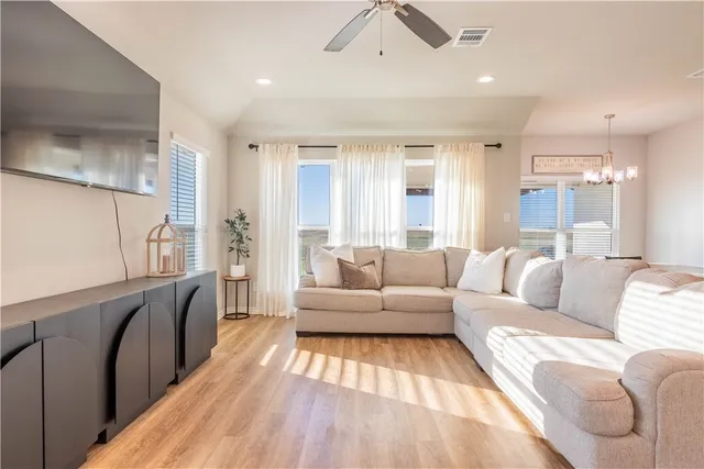 a living room with furniture and a wooden floor