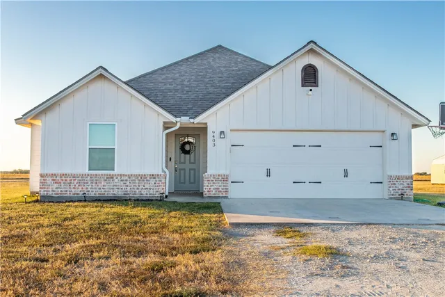 a big house with a big yard and more large trees