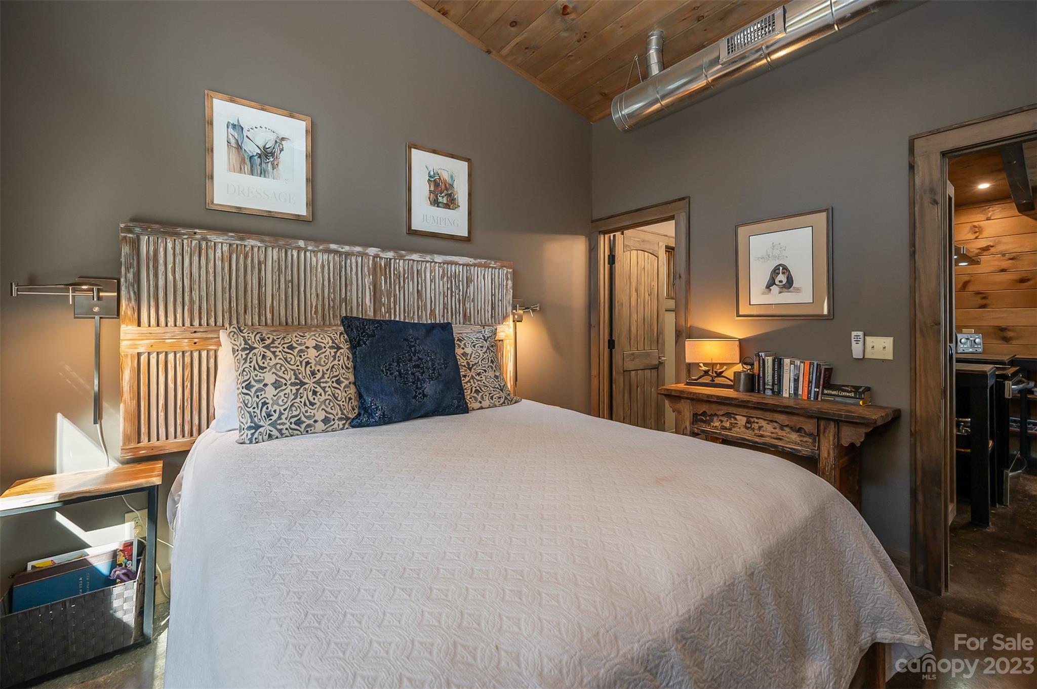 141 Herbert Page Road Tryon, NC 28782 - Photo 16 of 32 a bedroom with a bed and a fireplace