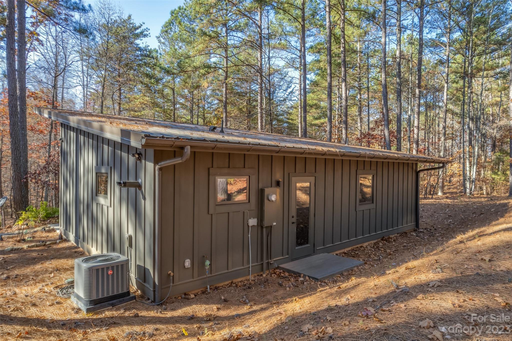 141 Herbert Page Road Tryon, NC 28782 - Photo 28 of 32 a view of a house with a small yard and wooden fence