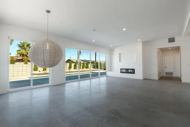 a view of an empty room with a kitchen