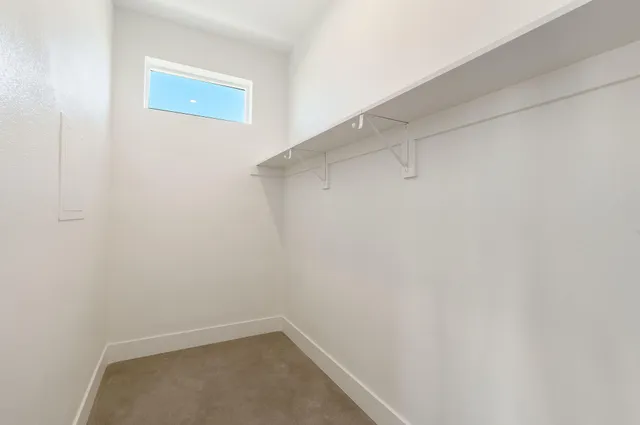a view of a hallway with wooden shelves